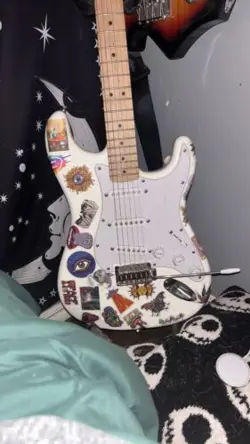 WHITE ELECTRIC FENDER GUITAR WITH STICKERS