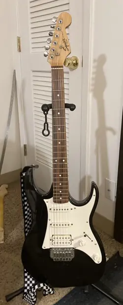 BLACK IBANEZ GIO GUITAR WITH FENDER SE SQUIRE NECK.