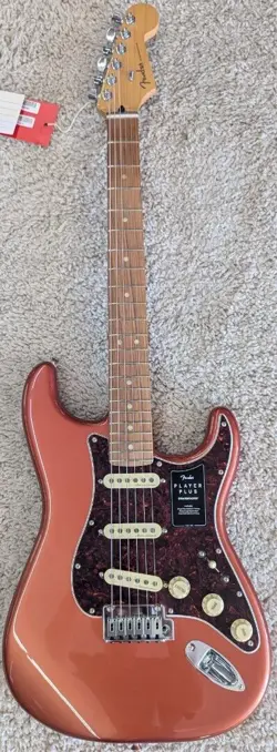 FENDER PLAYER PLUS STRATOCASTER®, PAU FERRO FINGERBOARD, AGED CANDY APPLE RED