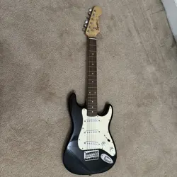 BLACK FENDER SQUIER MINI  ELECTRIC GUITAR  (USED). NEEDS NEW STRINGS