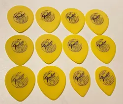 VINTAGE FENDER 1980’S-YELLOW TEARDROP GUITAR PICKS-LOT OF 12 NOS .73 GAUGE-NOS