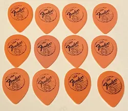 VINTAGE FENDER 1980’S-SMALL ORANGE TEARDROP PICKS-LOT OF 12 NOS-.60 GAUGE-UNUSED
