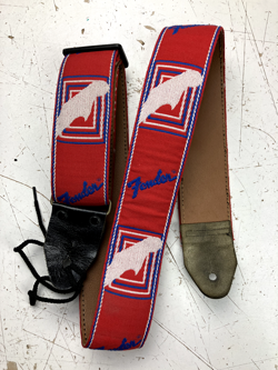 USED VTG FENDER MONOGRAMMED GUITAR STRAP (RED/WHITE/BLUE) W. BROWN BACK