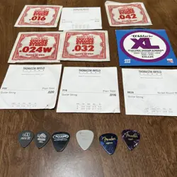 GUITAR STRINGS LOT OF 9 AND PICKS  FENDER AND MISC.