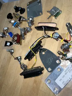 LOT OF MISC. FENDER ELECTRIC GUITAR PARTS, PICKUPS, KNOBS, POTS ,PLATE STRAT