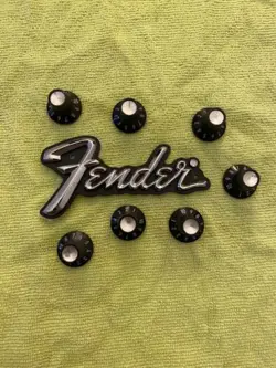 VINTAGE FENDER LOGO PLATE WITH 7 SILVER TOP, SKIRTED CONTROL KNOBS