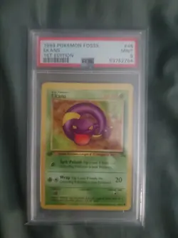 1999 Pokemon Fossil Ekans 1st Edition PSA 9 - Image 1