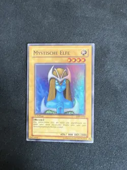 Yugioh MYSTICAL ELF, LOB-g050 Super Rare German 1st Edition Blue Eyes White - Image 1