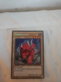 Yugioh LCJW-EN143 â€“ Sabersaurus â€“ SECRET RARE 1st Edition - Image 1