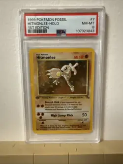 1999 POKEMON FOSSIL 1ST EDITION #7 HITMONLEE-HOLO PSA 8 - Image 1